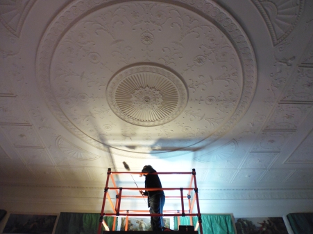 Hajira dusting the Library ceiling at Osterley Park (image: Laura Brooks)